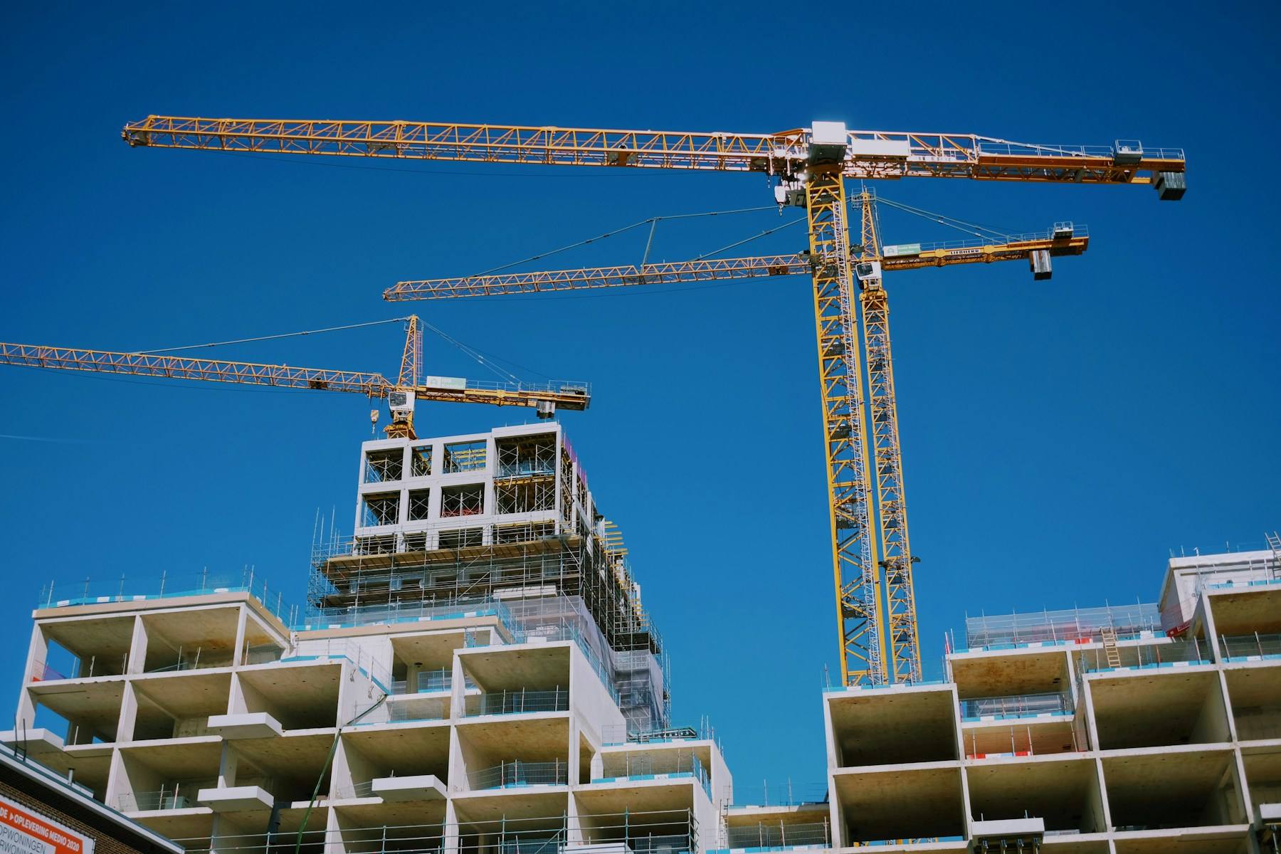 Cranes over a residential tower under construction